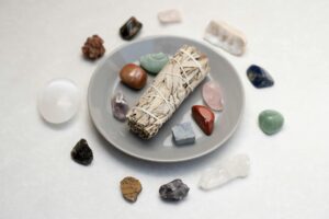 white sage and stones on ceramic plate