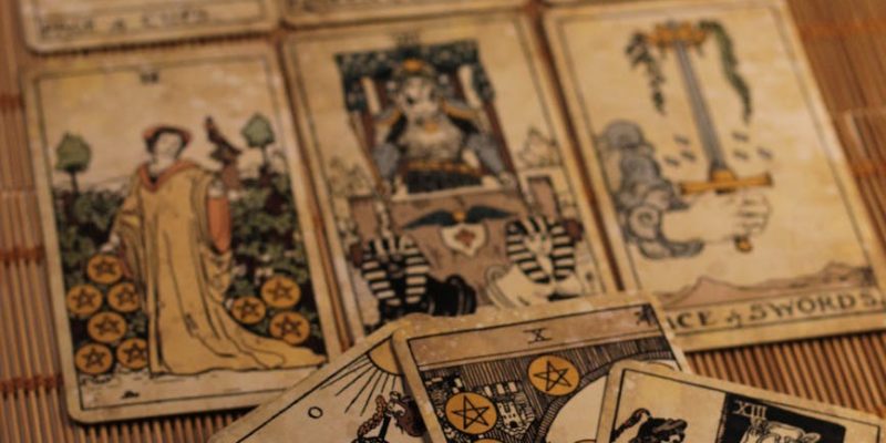 vintage tarot cards spread on bamboo mat
