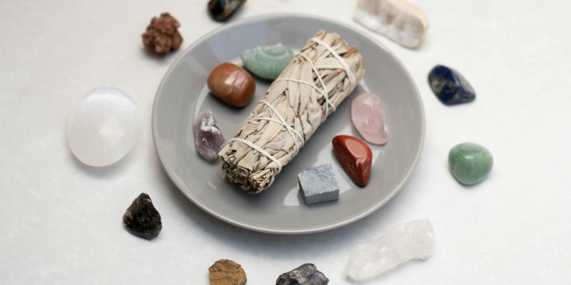 white sage and stones on ceramic plate